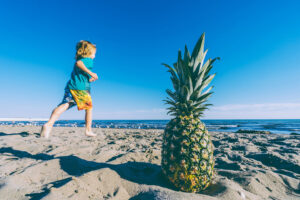 kid-playing-beach-pineapple