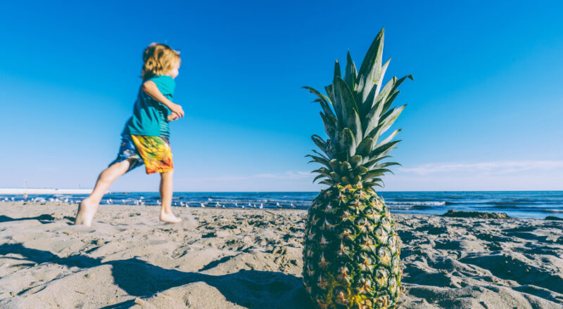 kid-playing-beach-pineapple