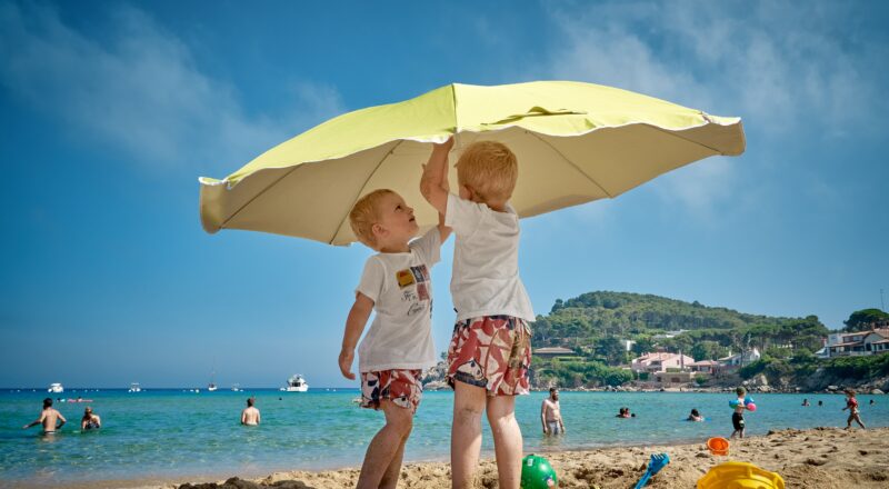 two-boys-playing-beach-umbrella